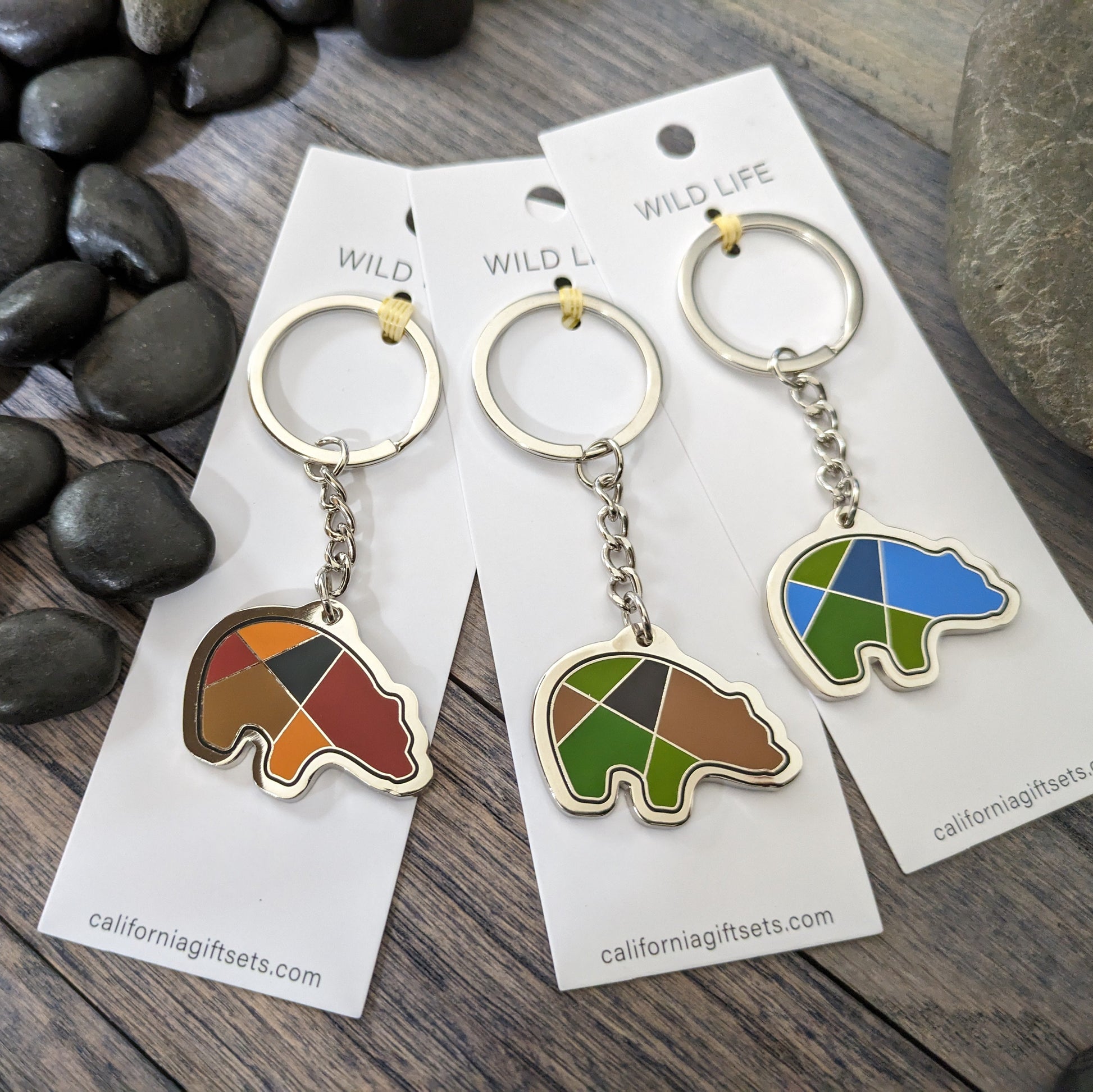 Quality Crafted Elegant -Silver Enamel Bear keychains in 3 Beautiful color settings of Southwestern Red/Black/brown, another one in forest Brown/green/black and a third one blue/green/darker blue. 
Each Key chain is mounted on sturdy 1.75" x 5" Pure White Card for a beautiful display.