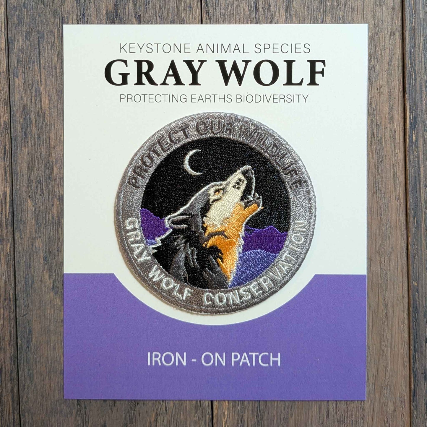 Wolf conservation -Embroidered Howling Wolf Iron- On Patch. Quality eco threads rich deep  purple mountains, vibrant Grey and Black fur colors threads. 2.5" diameter perfect for  fabric , hats, back packs.
